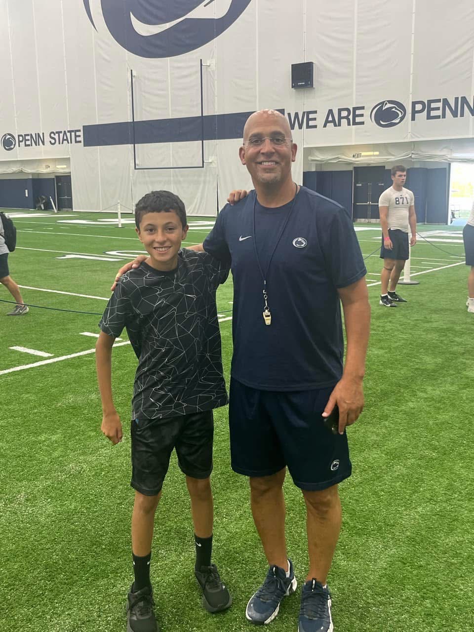 Coach Acosta at Penn State with a young athlete